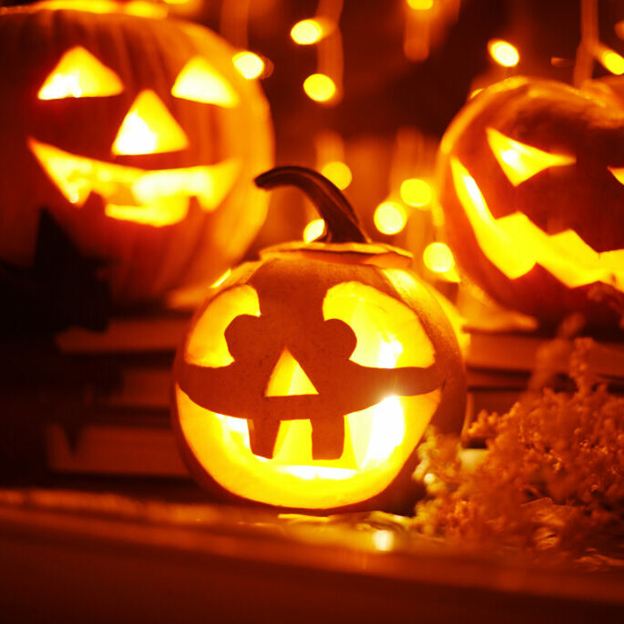 Jack-o-lanterns and other Halloween objects in a window